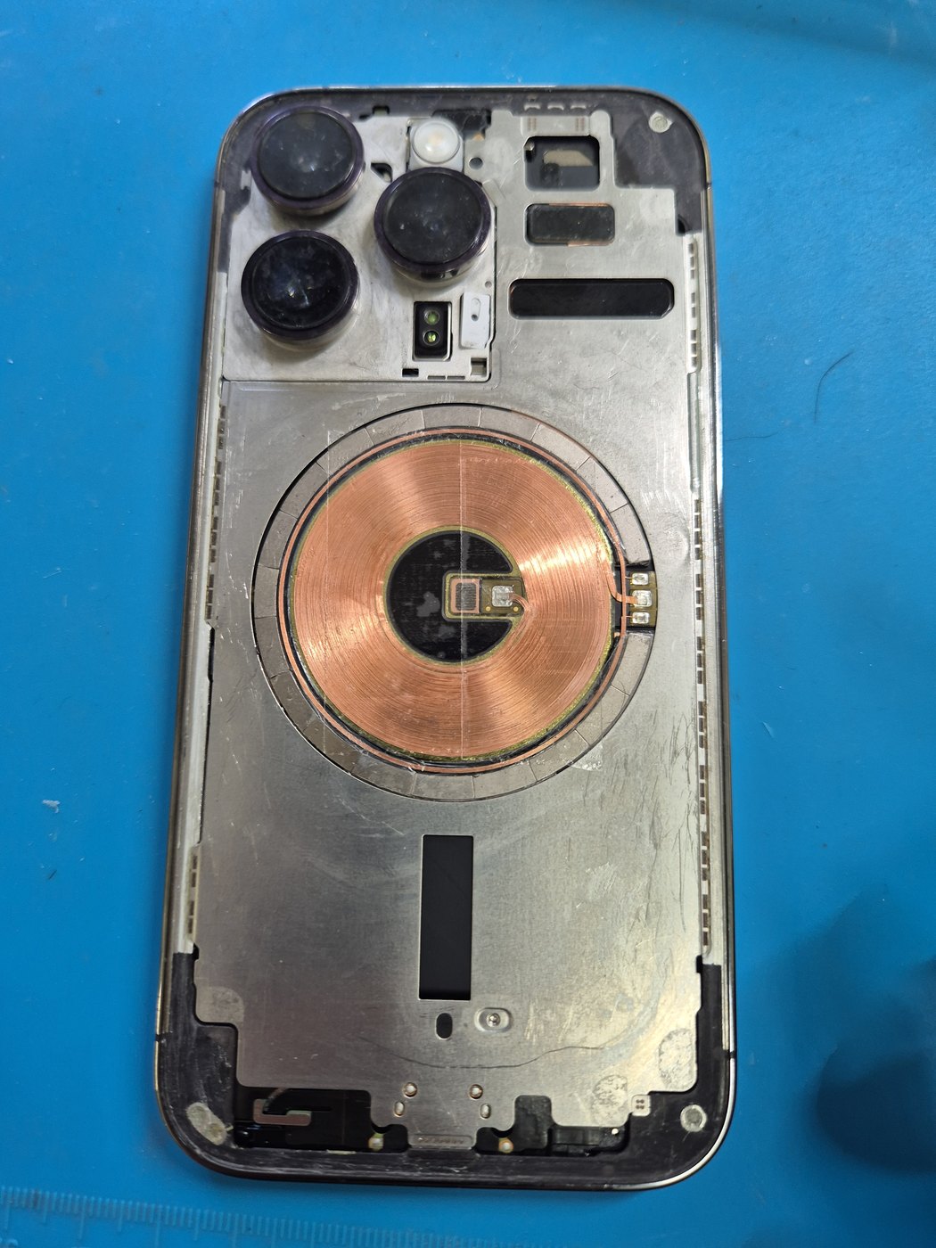 Opened iPhone showing internal battery area during repair