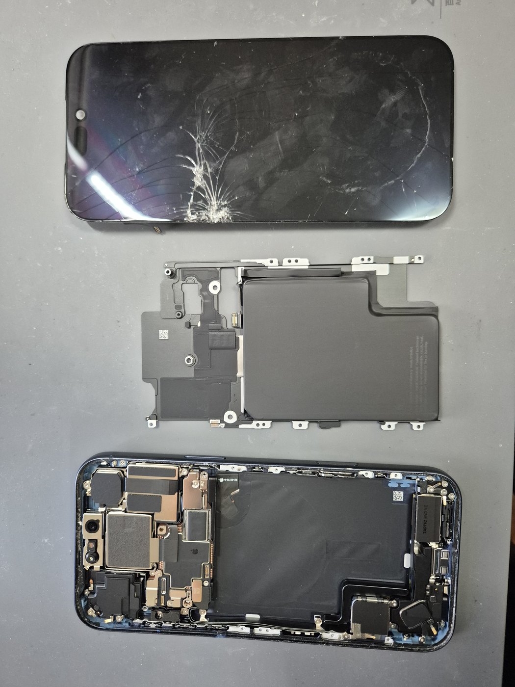 Cracked phone screen separated from the internal assembly during repair